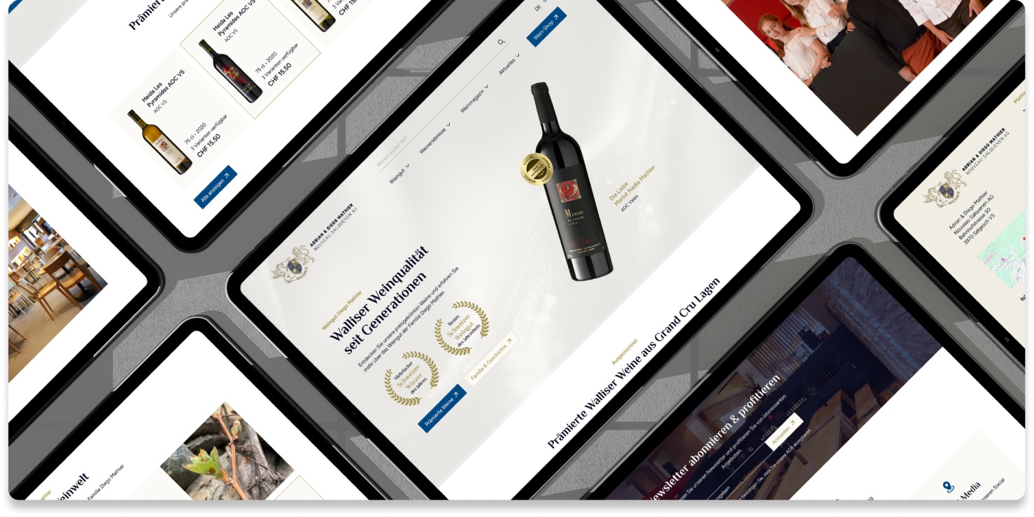 Mehrere Tablets zeigen eine Weingut-Website mit Weinflaschen, Auszeichnungen und Informationsseiten, die in einem Rastermuster auf einer grauen Oberfläche angeordnet sind.